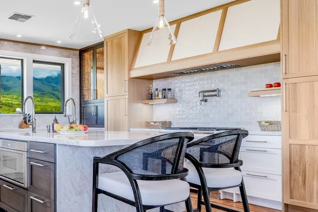 a dining room with stainless steel appliances kitchen island a table and chairs