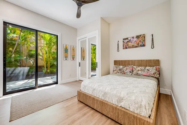 a bedroom with a large bed and a large window