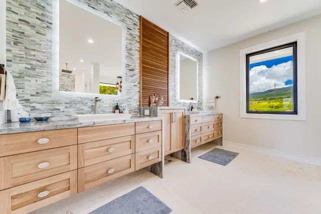 a spacious bathroom with a double vanity sink and a window