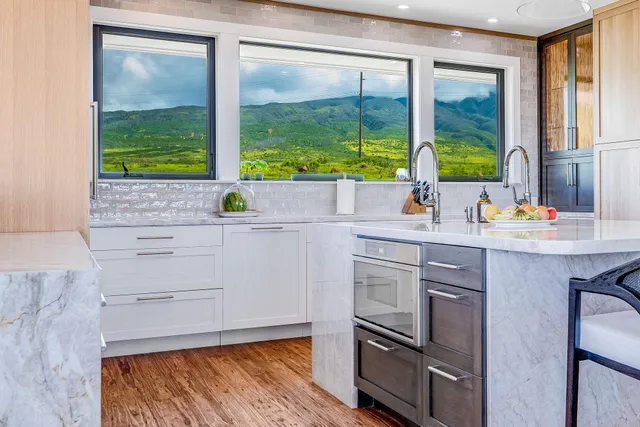 a kitchen with a sink and a large window