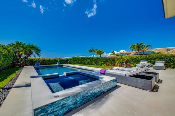 a view of a patio with couches table and chairs with plants