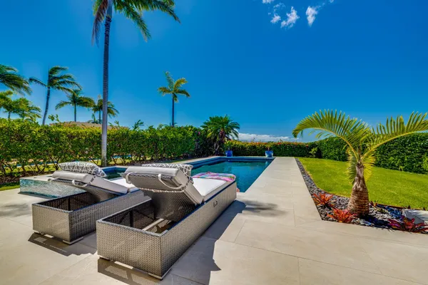 a view of swimming pool with outdoor seating and plants