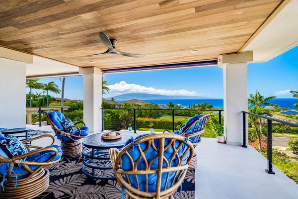 a view of an chairs and table in patio
