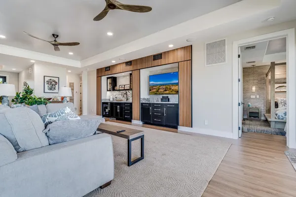 a living room with furniture and a wooden floor
