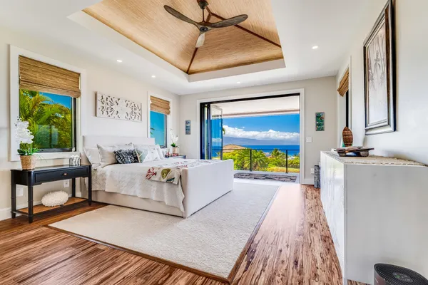 a living room with furniture a flat screen tv and a floor to ceiling window