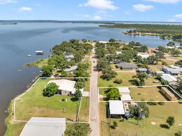 an aerial view of a house with a lake view