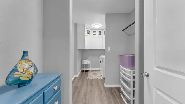 a room with a sink and wooden floor