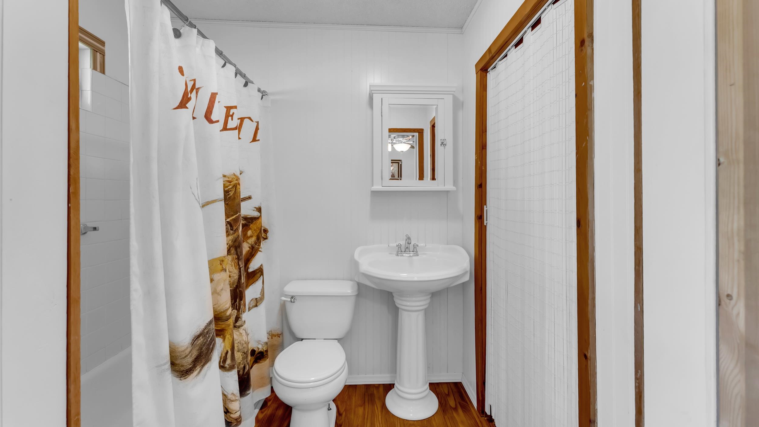 1570 Breezeway Tow, TX 78672 - Photo 17 of 30 a bathroom with a toilet and a shower curtain