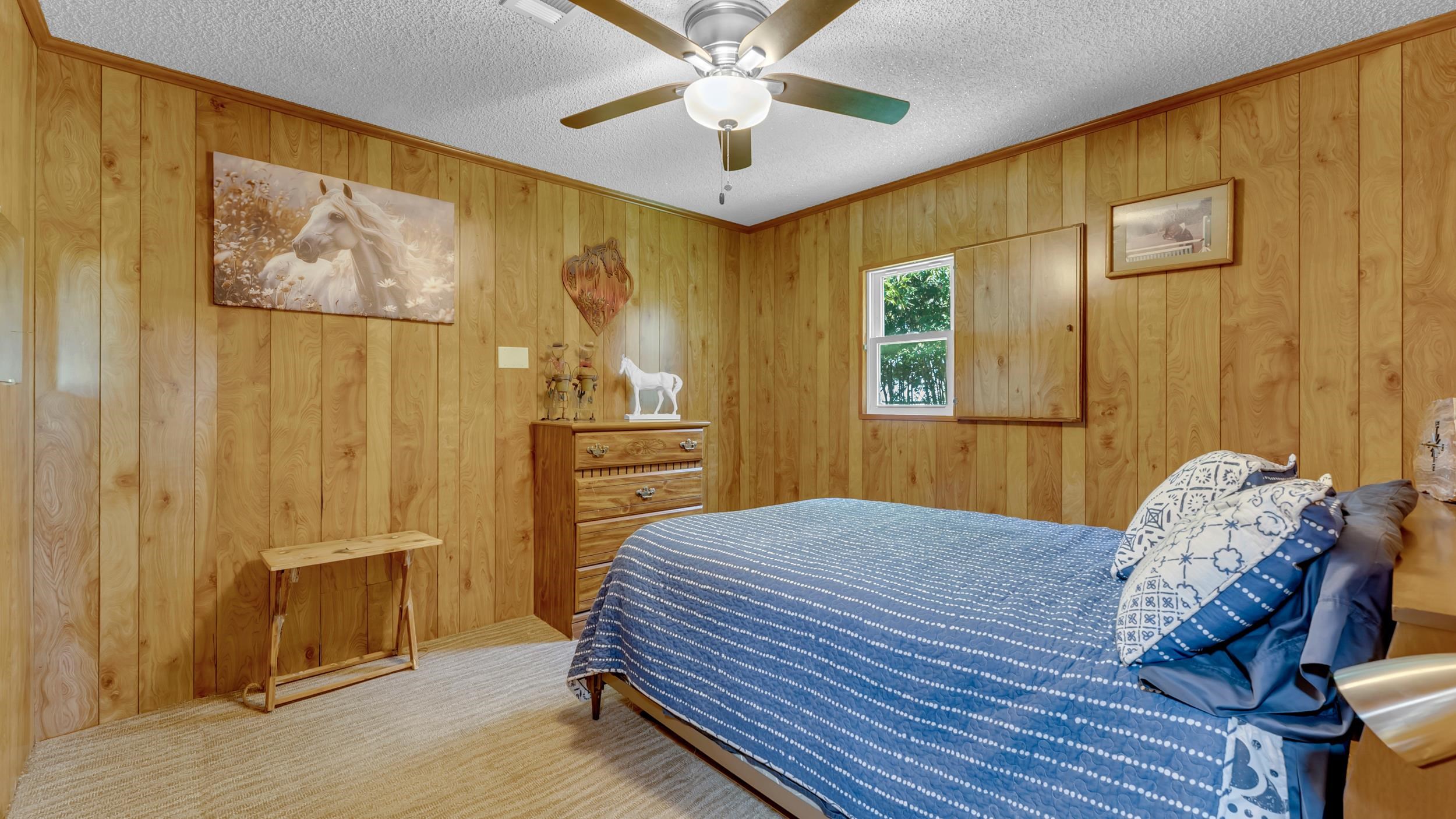 1570 Breezeway Tow, TX 78672 - Photo 18 of 30 a bedroom with a bed and a chandelier