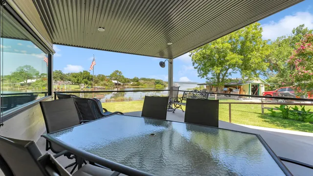 a view of a balcony with lake view and a large window