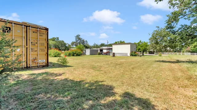 a view of a big yard with an outdoor seating