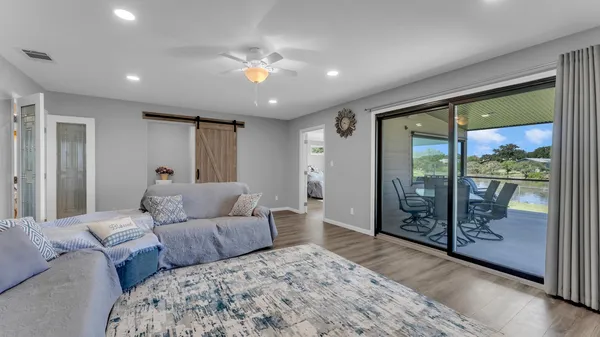 a living room with furniture and a floor to ceiling window