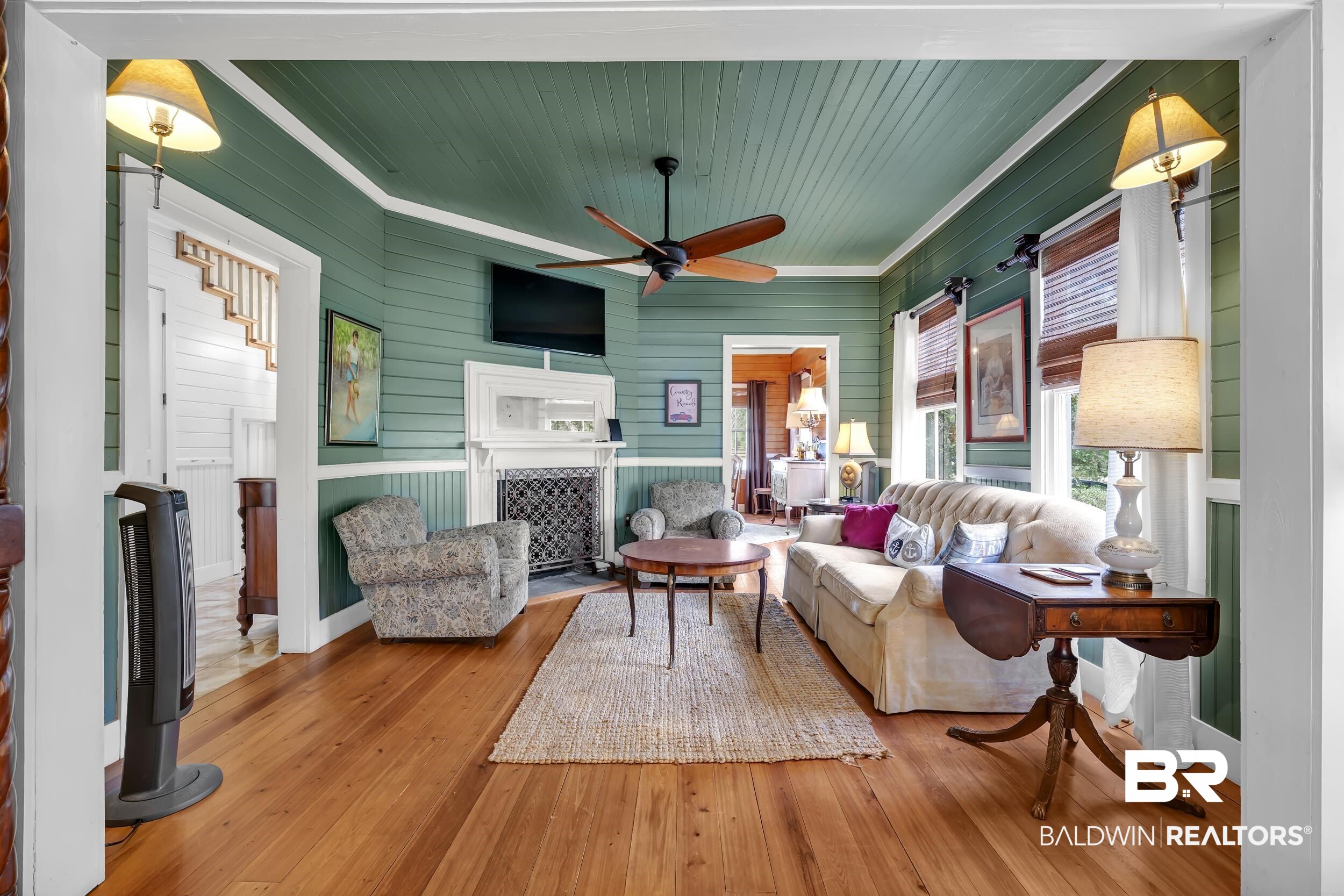 13232 Mary Ann Bch Road Fairhope, AL 36532 - Photo 15 of 79 Living room with wooden walls, wood-type flooring, wood ceiling, ceiling fan, and a fireplace with flush hearth
