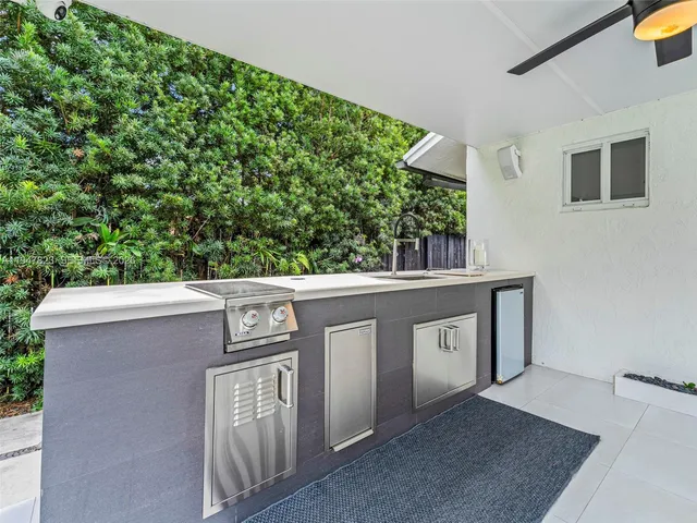 a view of a terrace with furniture and a chandelier