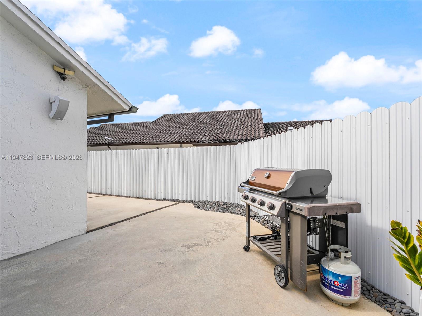 7753 Northwest 189th Street, Unit 1 Hialeah, FL 33015 - Photo 13 of 30 a view of a terrace with furniture and a chandelier