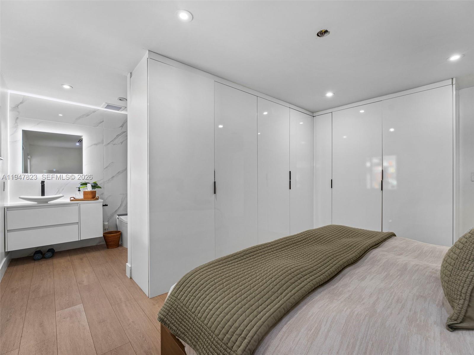 7753 Northwest 189th Street, Unit 1 Hialeah, FL 33015 - Photo 16 of 30 a bedroom with a bed and a large window