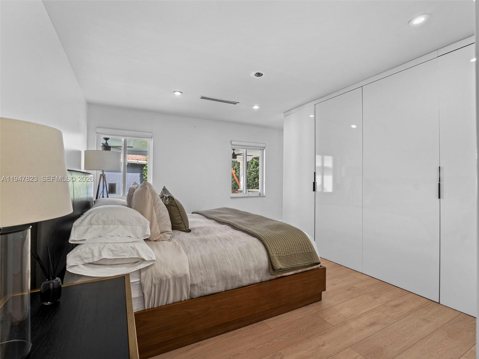 7753 Northwest 189th Street, Unit 1 Hialeah, FL 33015 - Photo 19 of 30 a bedroom with a bed and a table