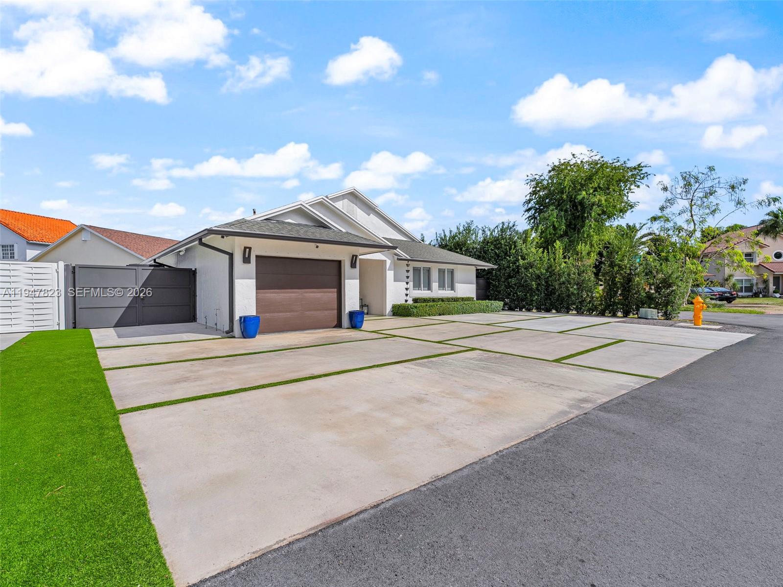 7753 Northwest 189th Street, Unit 1 Hialeah, FL 33015 - Photo 2 of 30 a house with tree in front of it