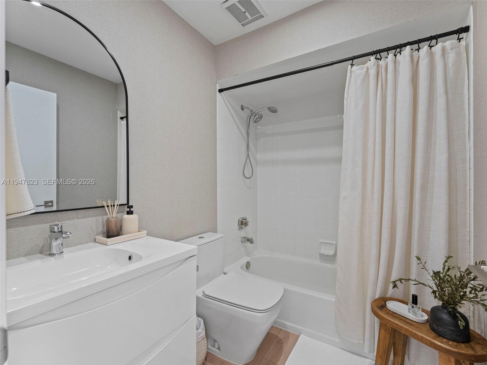 7753 Northwest 189th Street, Unit 1 Hialeah, FL 33015 - Photo 27 of 30 a bathroom with a sink toilet and shower