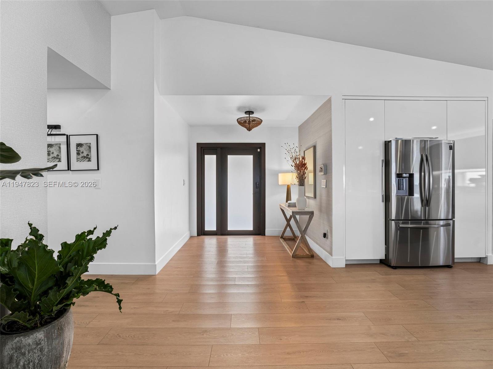 7753 Northwest 189th Street, Unit 1 Hialeah, FL 33015 - Photo 4 of 30 a view of a refrigerator in kitchen and entryway