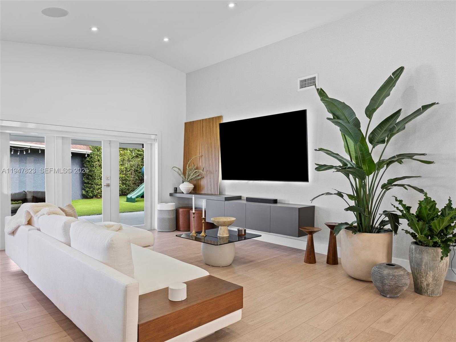 7753 Northwest 189th Street, Unit 1 Hialeah, FL 33015 - Photo 5 of 30 a living room with furniture and a flat screen tv