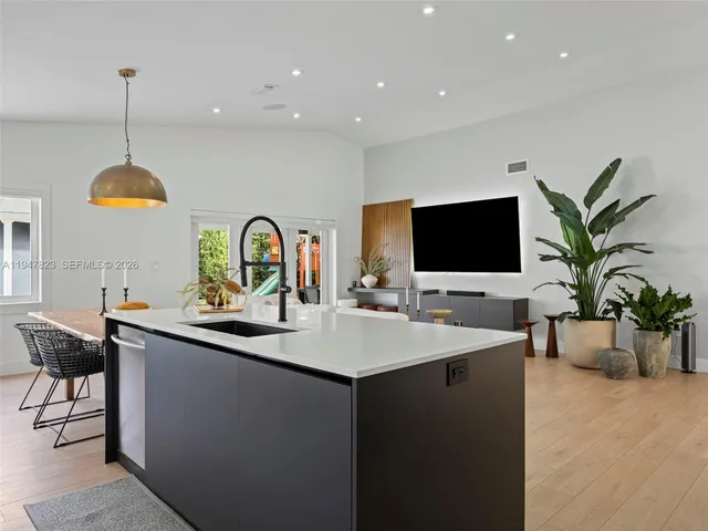 a swimming pool with view of kitchen and dining room