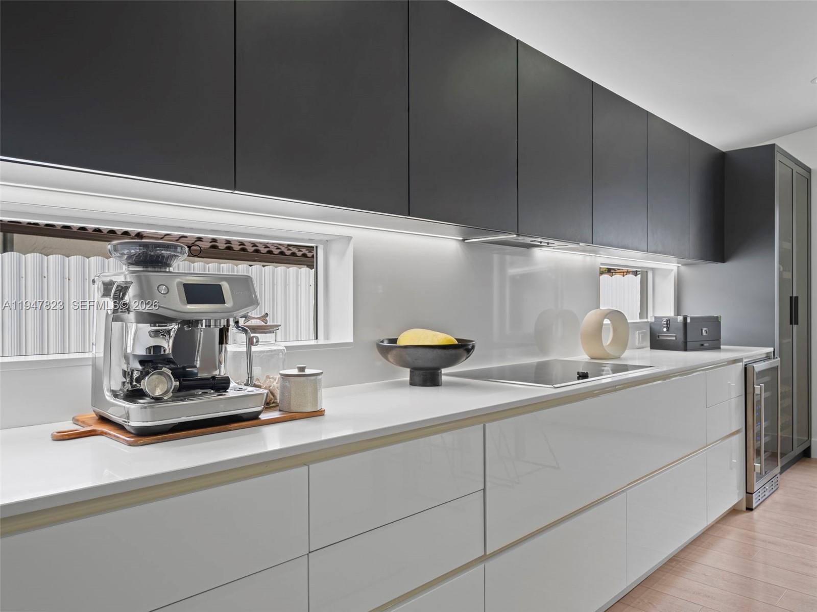 7753 Northwest 189th Street, Unit 1 Hialeah, FL 33015 - Photo 10 of 30 a kitchen with a sink and cabinets