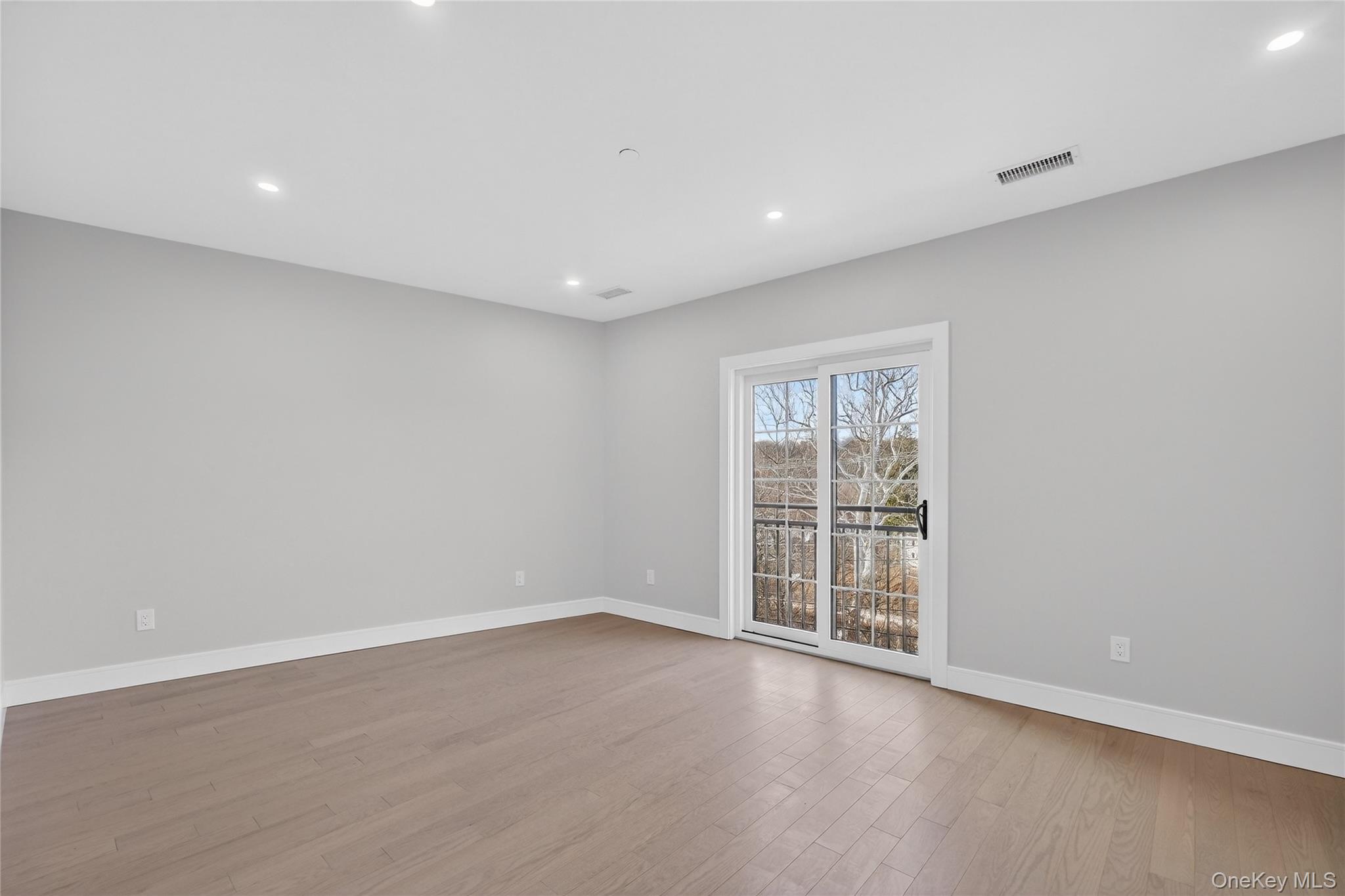 10 Market Street, Unit J Wappingers Falls, NY 12590 - Photo 10 of 18 an empty room with wooden floor and windows