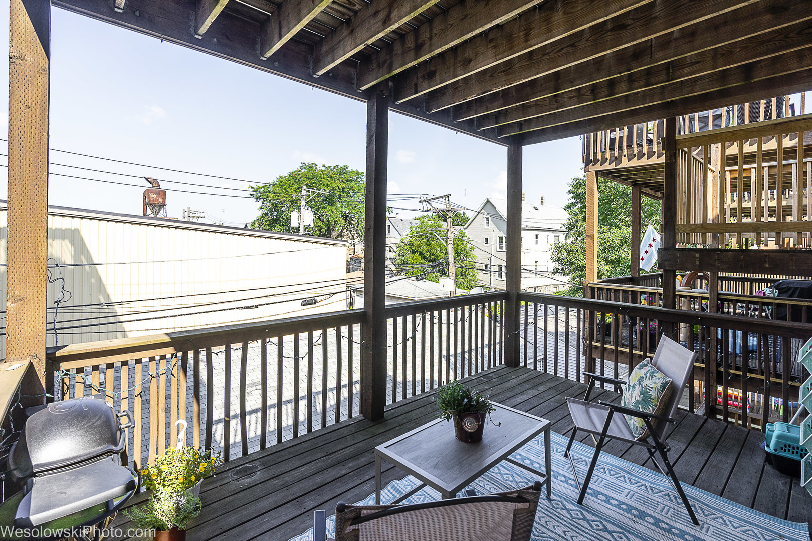 3042 North Oakley Avenue, Unit 2S Chicago, IL 60618 - Photo 15 of 19 a view of a balcony with chairs and wooden floor