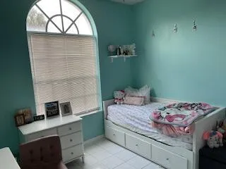 a bedroom with a bed and a window