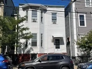 a couple of cars parked in front of a house