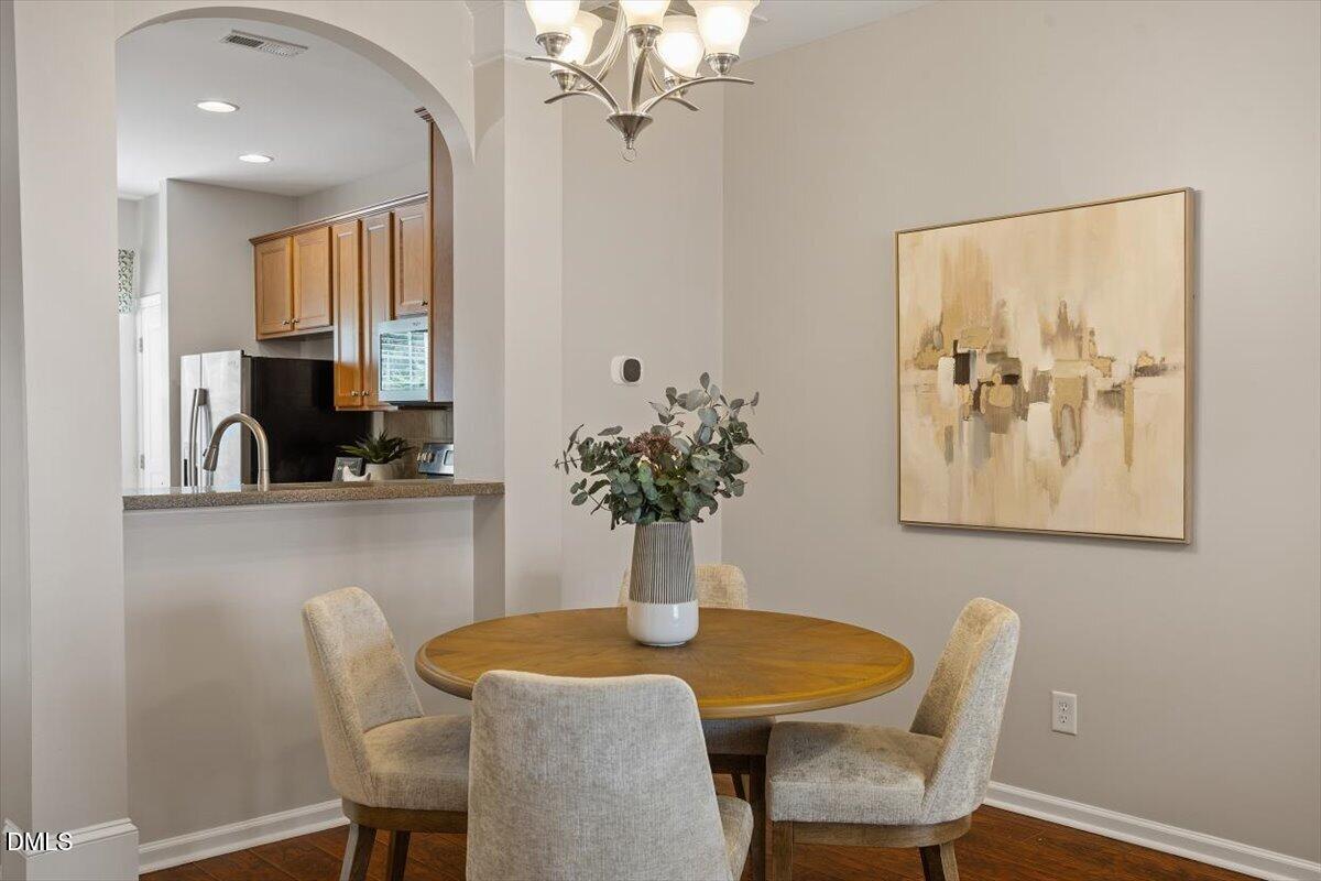 7734 Winners Edge Street Raleigh, NC 27617 - Photo 10 of 37 a dining room with furniture and wooden floor
