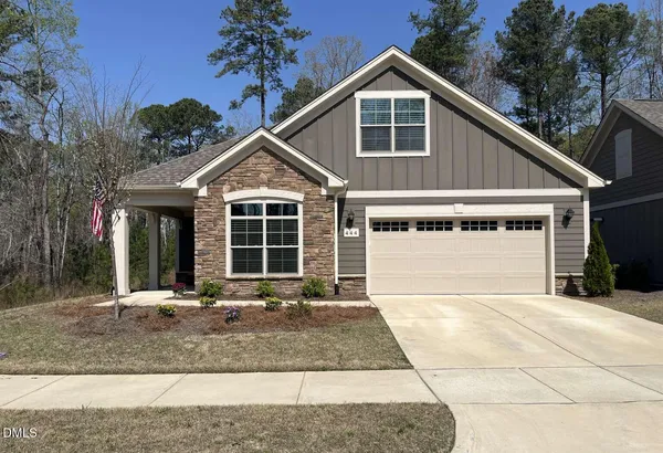 a front view of a house with yard and porch