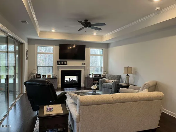 a living room with furniture a flat screen tv and a fireplace