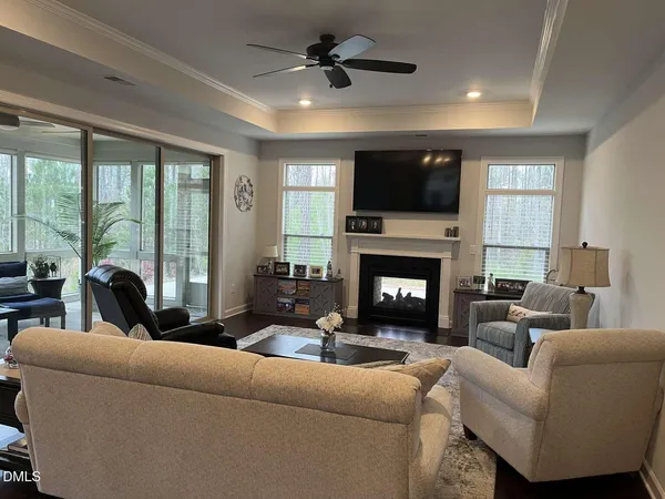a living room with furniture a fireplace and a flat screen tv