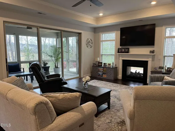 a living room with furniture a flat screen tv and a fireplace