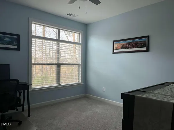 a room with a cabinet and painting on the wall