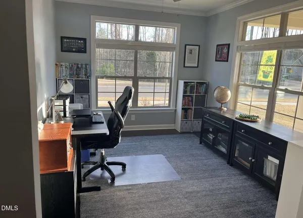 a bedroom with a bed and two windows