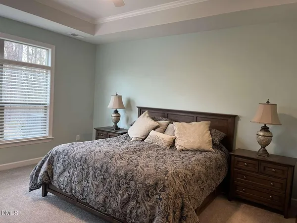 a bedroom with a bed and cabinet