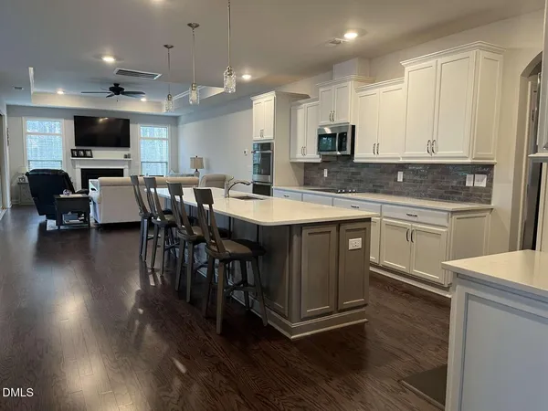 a kitchen with a sink appliances and cabinets