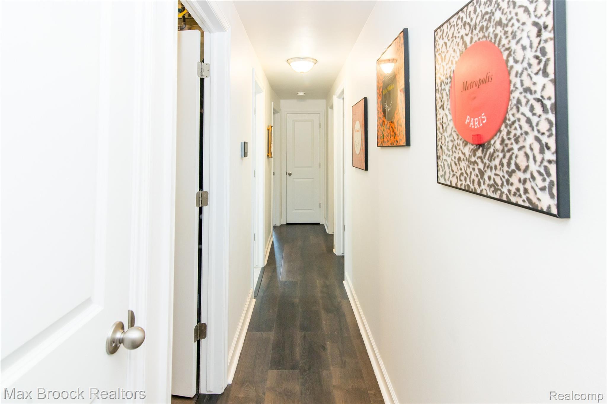 6799 East Dartmoor Road West Bloomfield, MI 48322 - Photo 16 of 36 Hallway featuring dark wood-finish flooring, white baseboards, and white walls