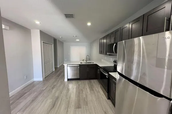 a kitchen with stainless steel appliances a refrigerator and a sink
