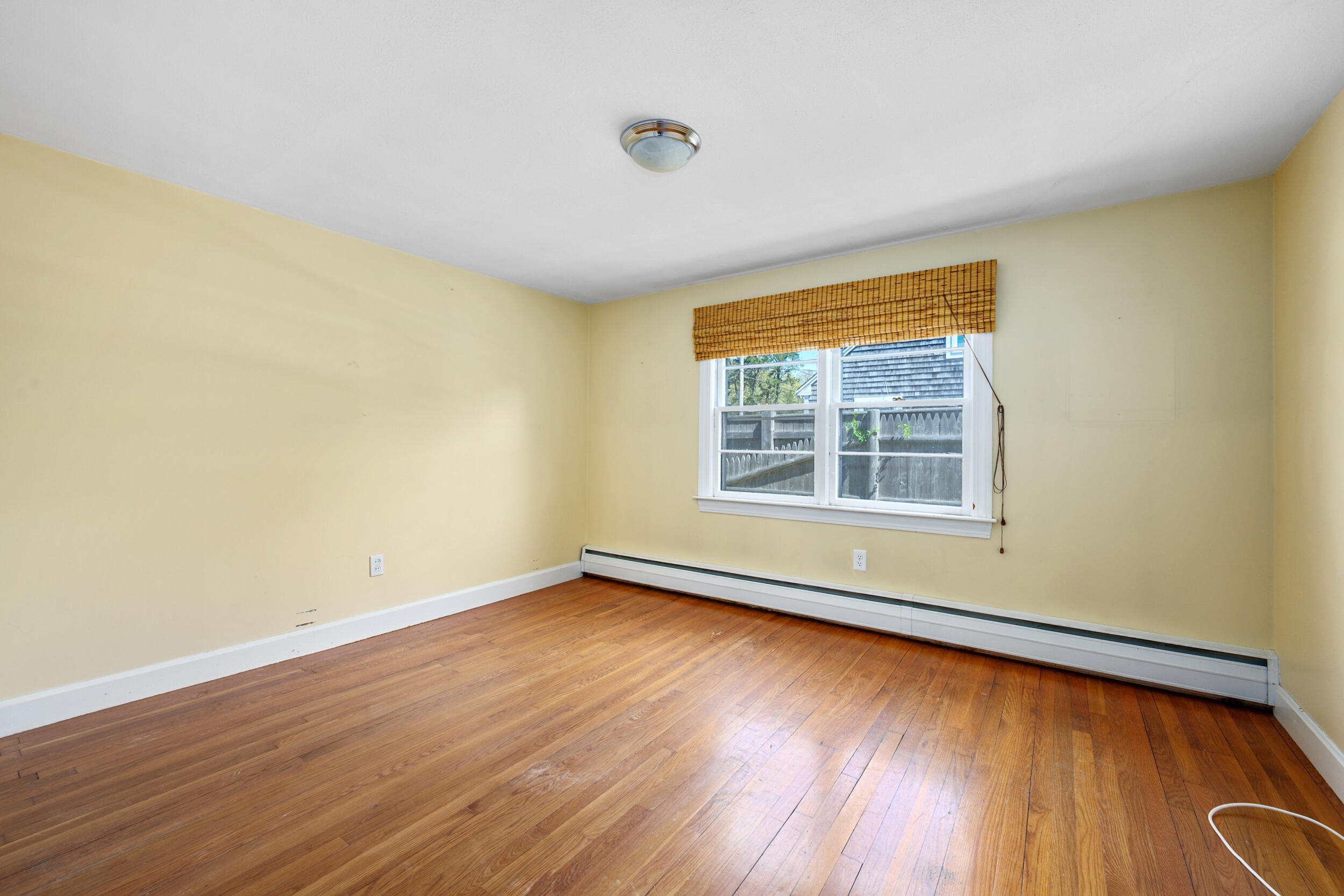 129 Belmont Road West Harwich, MA 02671 - Photo 6 of 27 a view of an empty room with wooden floor and a window