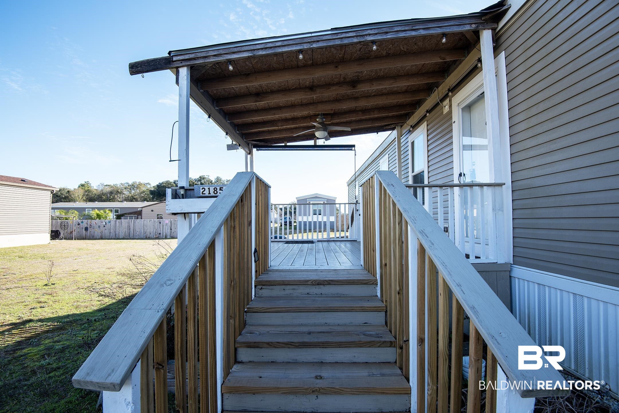 21859 West Side Loop Silverhill, AL 36576 - Photo 5 of 24 Wooden deck featuring ceiling fan and a yard