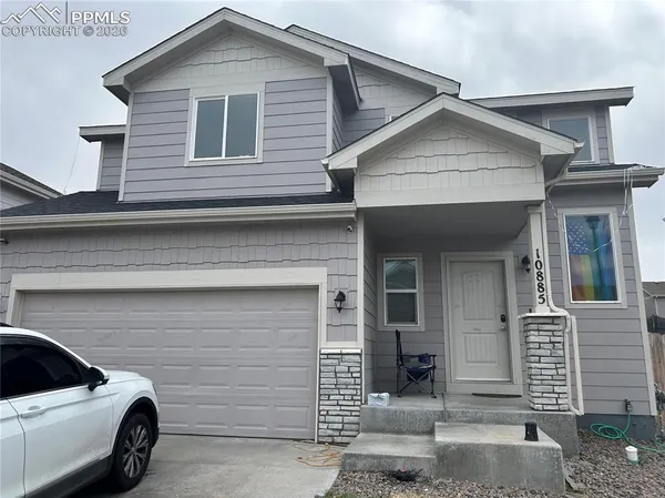 a view of a house with a parking space