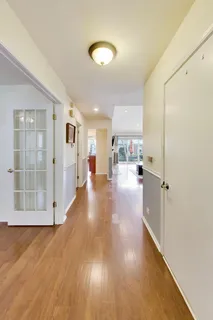 a view of a living room hardwood floor and a kitchen