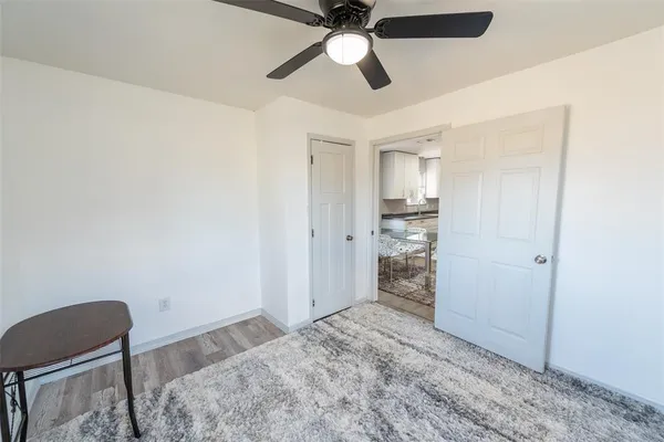 a view of a livingroom with a ceiling fan and window