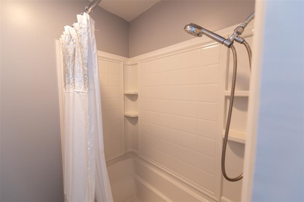 2339 Southwest County Road 3110 Mount Vernon, TX 75457 - Photo 20 of 31 a bathroom with a glass shower door