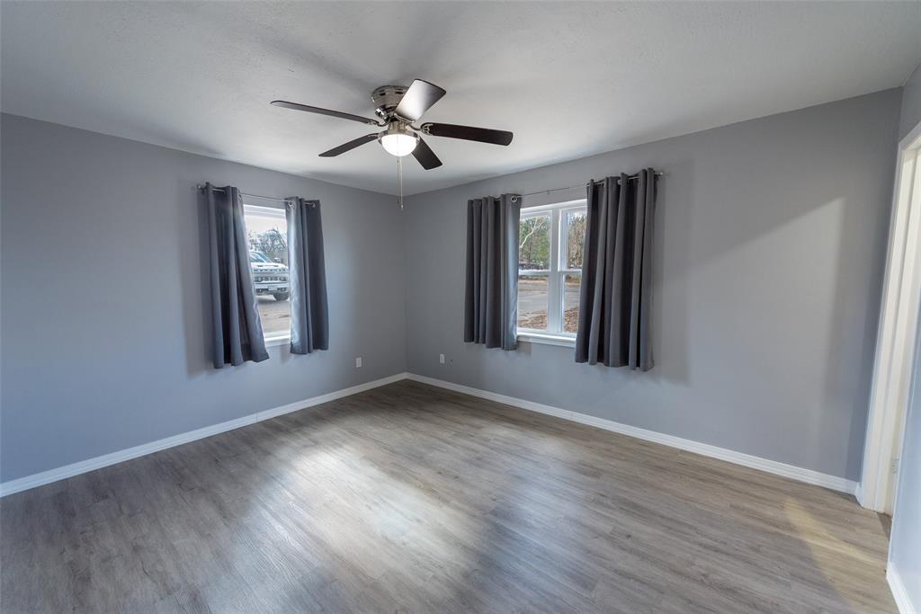 2339 Southwest County Road 3110 Mount Vernon, TX 75457 - Photo 21 of 31 a view of an empty room with wooden floor and a window
