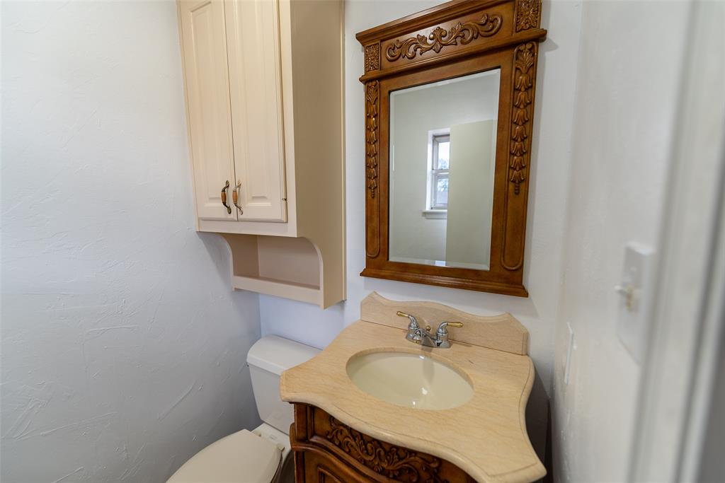 2339 Southwest County Road 3110 Mount Vernon, TX 75457 - Photo 22 of 31 a bathroom with a sink and a mirror